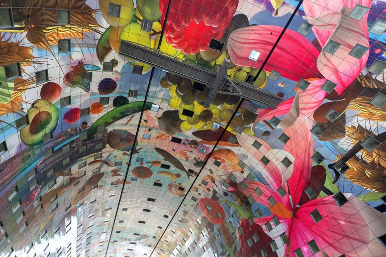 The ceiling of the Markthal consists of approximately 4.500 densely perforated aluminium panels which prevent sound echoing. ©Ossip van Duivenbode